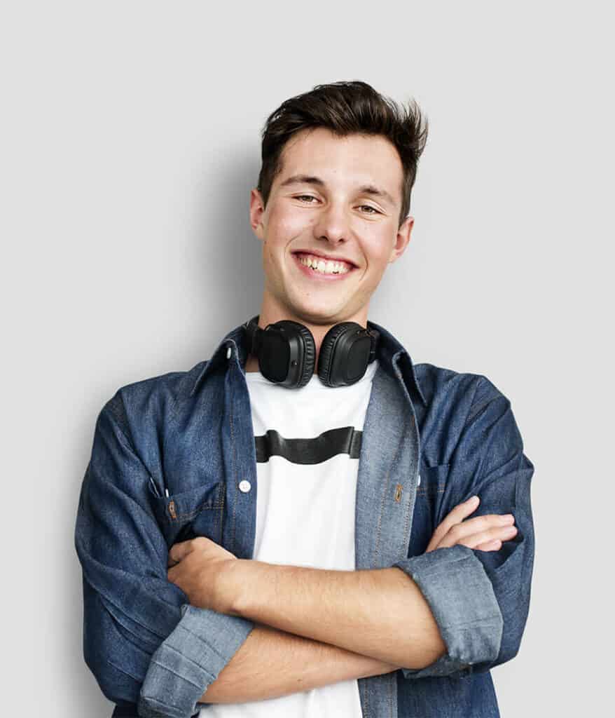 young white male smiling with headphones around his neck