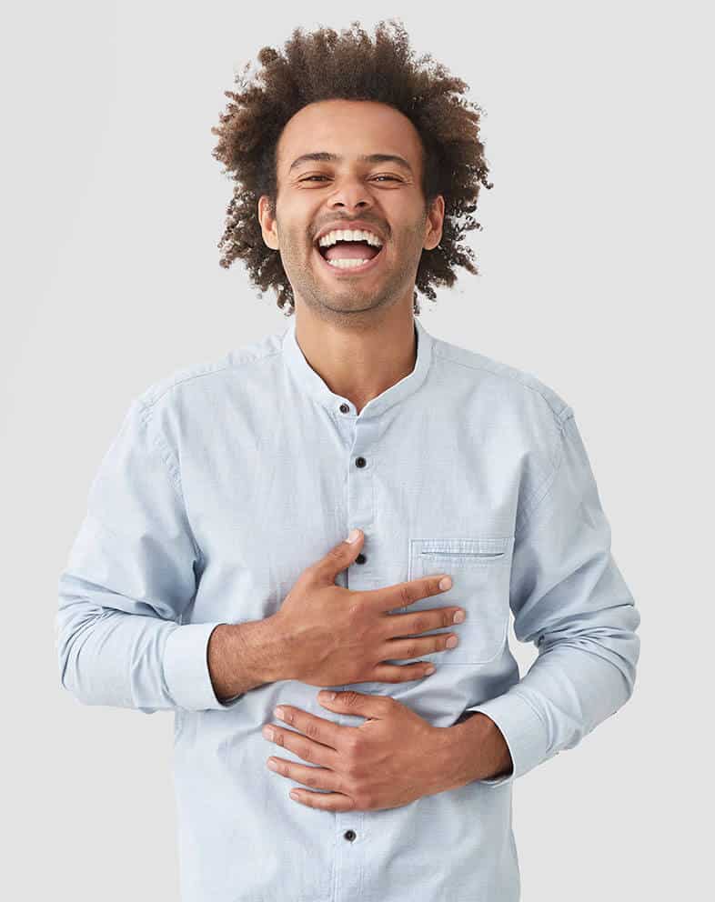 young african american man laughing while holding his stomach