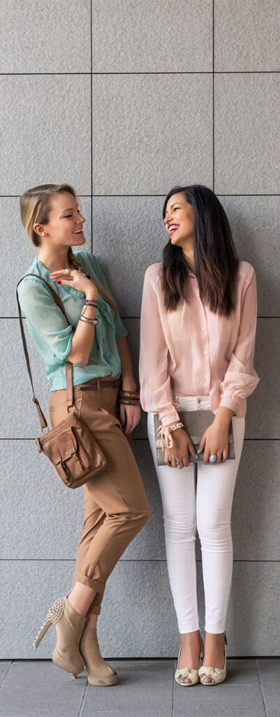 two young stylish women talking and laughing